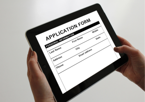 hands holding digital tablet with generic application form 